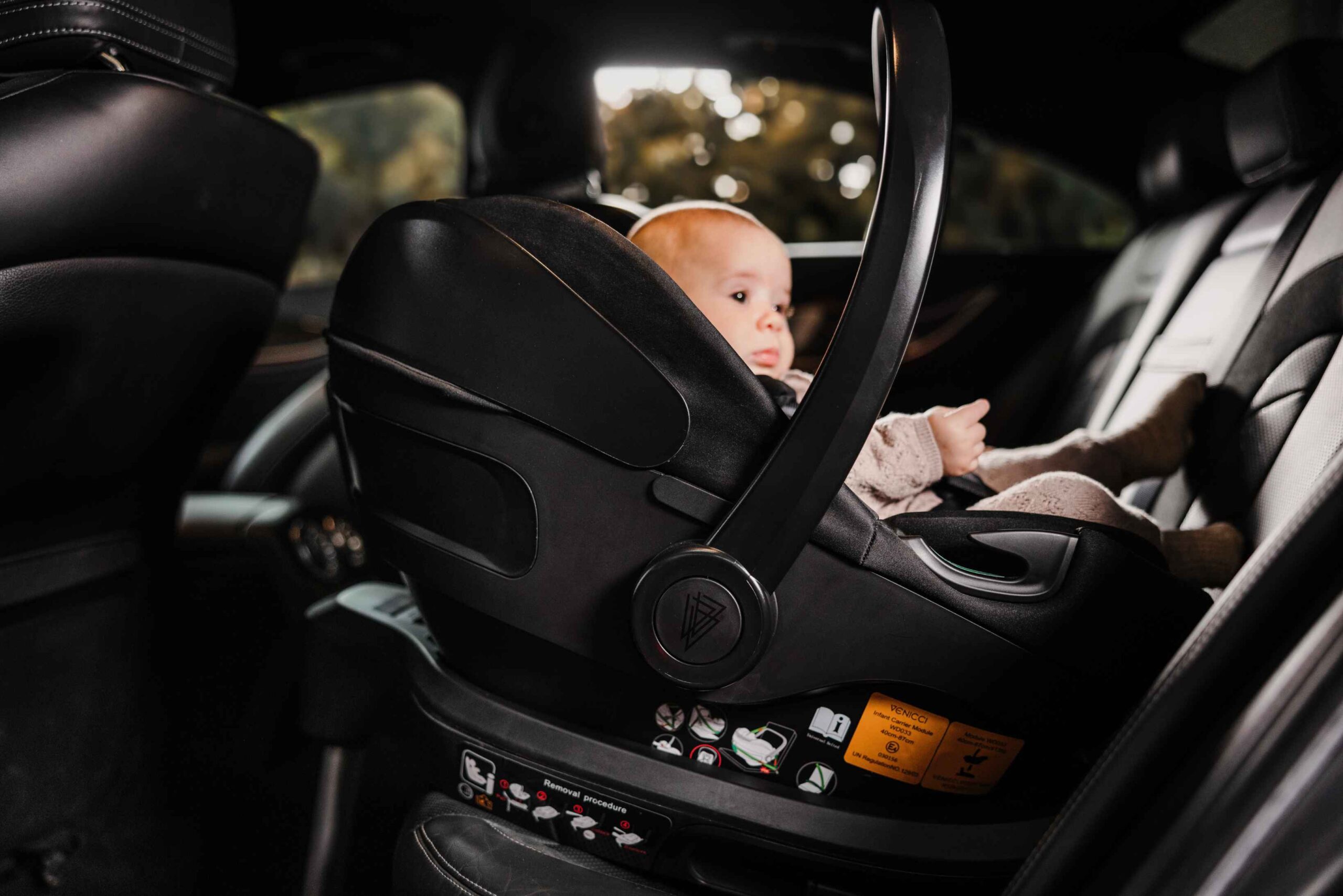 Child in car seat inside car